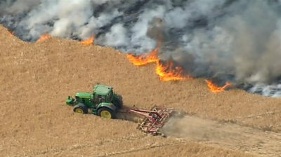 A tractor next to wildfire