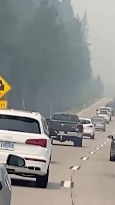 Cars flee wildfires in California