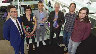 A group of six people with their award