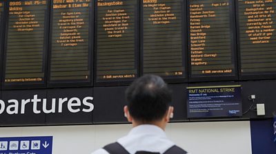 Man stares at rail station departure boards