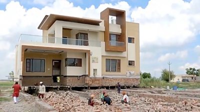 India farmer moves two-storey home - an inch at a time - BBC News