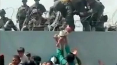 Baby being passed to soldiers