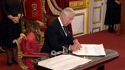 King Charles III signing papers at his proclamation ceremony