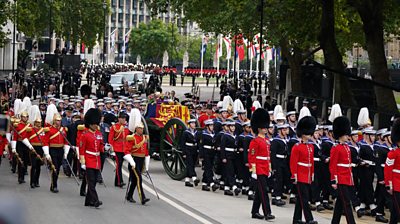 A bearer party lifts the Queen's coffin from Westminster Hall and carries it in procession to the state gun carriage.