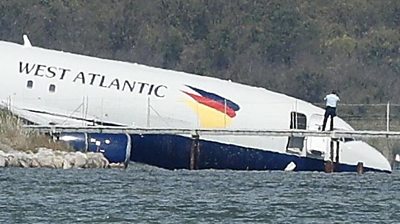 Plane partially submerged in lake