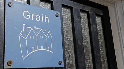 The sign for Graih on the outside door
