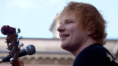 Ed Sheeran at a microphone