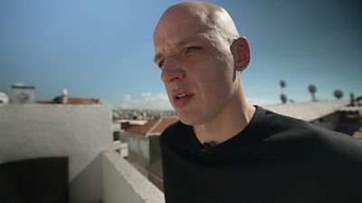 Sergey standing on a balcony