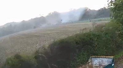 Tornado hits buildings in a field