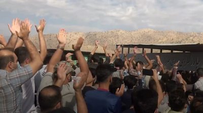People chanting in a cemetery