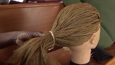 Hair extensions on a doll head