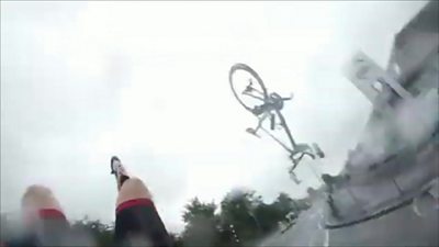 A bike in the air after a cyclist falls off