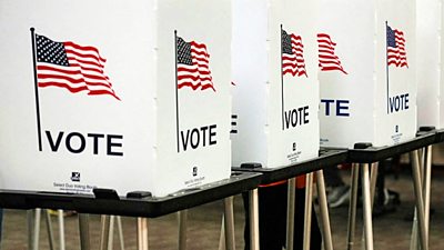 Voting booths with US flags on them