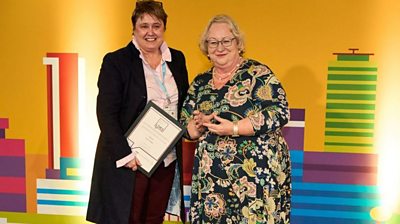 Local Democracy Reporter of the Year Tanya Fowles, left, receives her award from Jackie Weaver