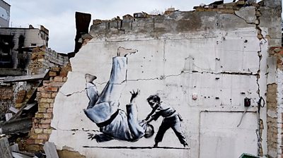 Banksy's artwork on the side of destroyed building in Ukraine