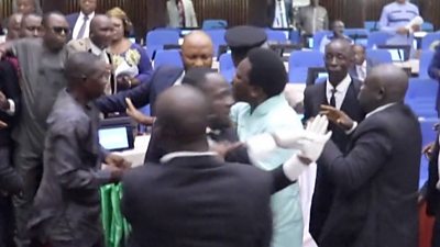 People in suits fighting in Parliament