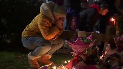 A woman at the vigil