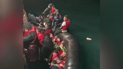 Migrants struggling to escape a sinking boat