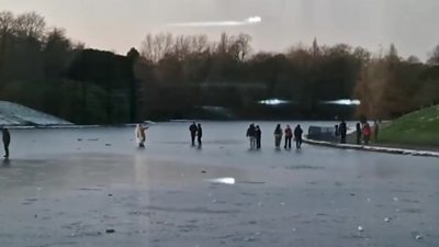 People skating on icy lake in Liverpool