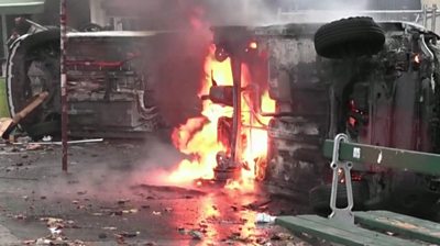 Car on fire after violent clashes in Paris