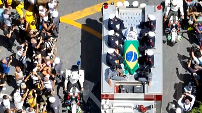 Pelu00e9's coffin carried on a fire engine through the streets of Santos