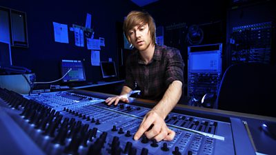 A man at a studio mixing desk