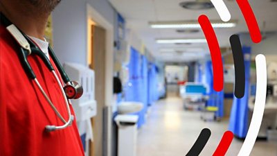 Inside of a hospital with a member of staff wearing a stethoscope around his neck