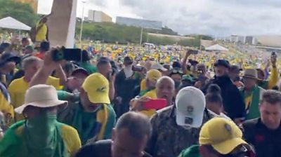 People wearing green and yellow storming Brazil's Supreme Court