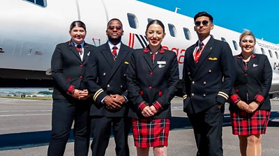 The crew of the UK’s largest regional airline stand infront of a plane