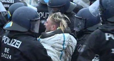 A protester being taken away by police