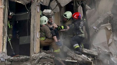 A woman being rescued from building hit by missile