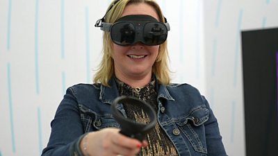 BBC Technology editor Zoe Kleinman wears a HTC Vive XR Elite headset and holds a controller