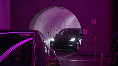 Tesla driving out of a tunnel