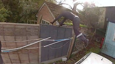 Suspect climbing a fence