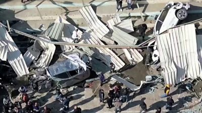 Drone still of wrecked cars and buildings