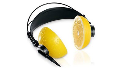 The logo for the Alfred Bradley Bursary Award - a set of headphones where the pads are half a lemon