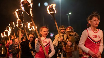 This year's fire festival has made history, with women and girls taking part in the procession for the first time.