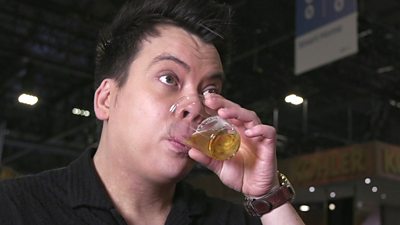 Nick Kwek tries a sample of beer in a small glass