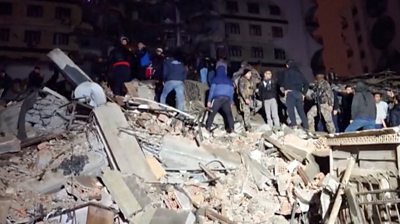 People stood on destroyed building