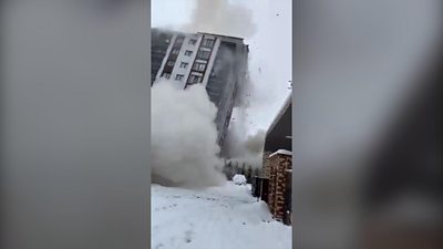 Building collapses with a cloud of smoke at base