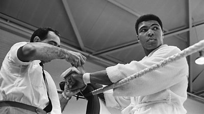 Angelo Dundee wrapping boxing tape around Muhammad Ali's hands. May 18, 1966.