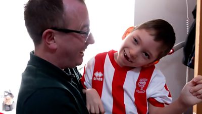 Child in father's arms.