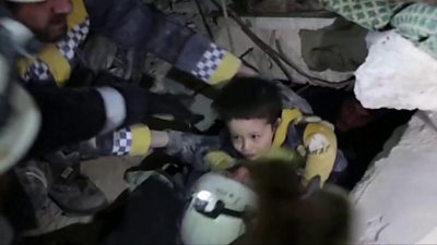 A boy is freed from rubble in Syria