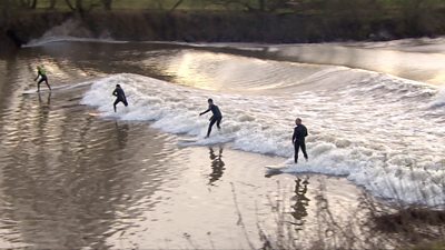 Surfers riding the wave of the River Severn