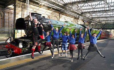 Dancers and pipers beside Flying Scotsman