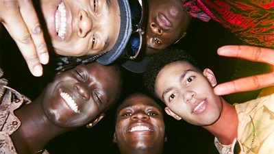 Teenagers crowd around in a circle with the photo taken from below