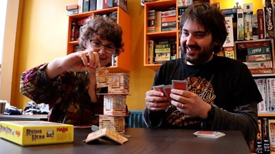 Meeple Perk board game cafe owners playing a game