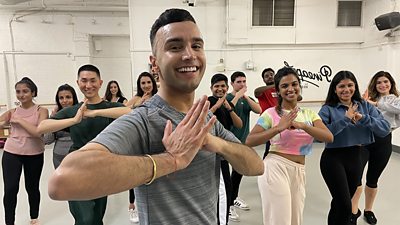 Anish dances with other dancers in the background