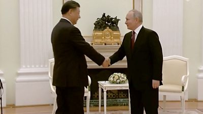 Presidents Xi and Putin shake hands