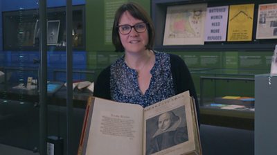 Museum curator with Shakespeare's First Folio